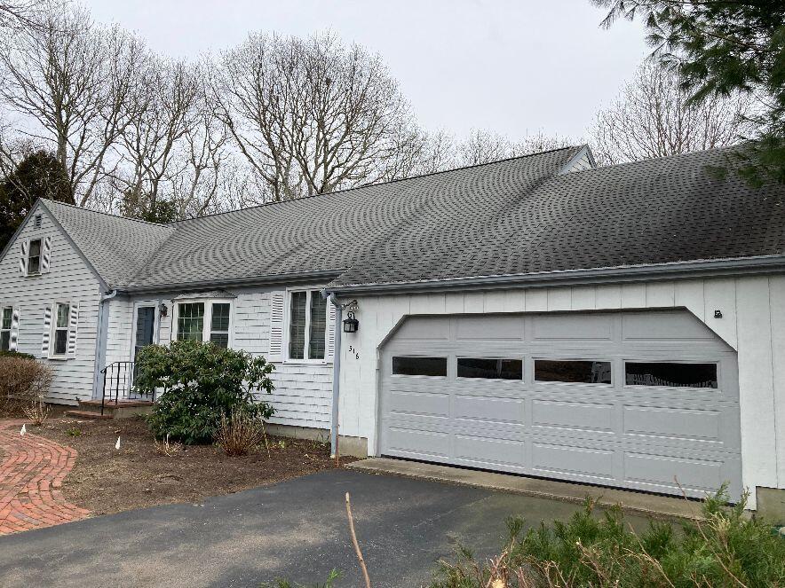316 Cap'n Lijah's Road Centerville, MA 02632 - Photo 40 of 45 a front view of a house with a garage