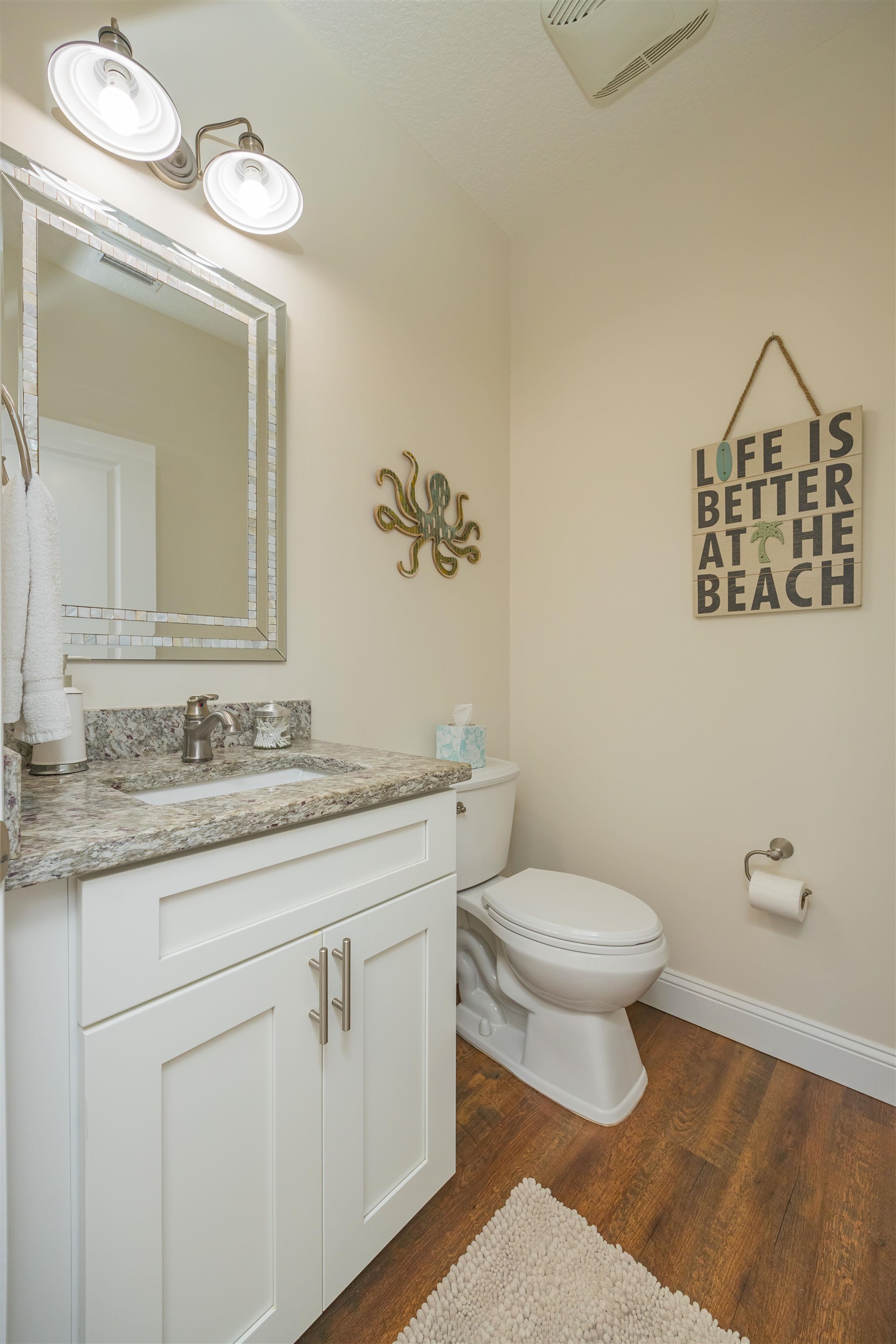 6832 Middleton Avenue St. Augustine, FL 32080 - Photo 17 of 47 a bathroom with a granite countertop sink a toilet and a mirror