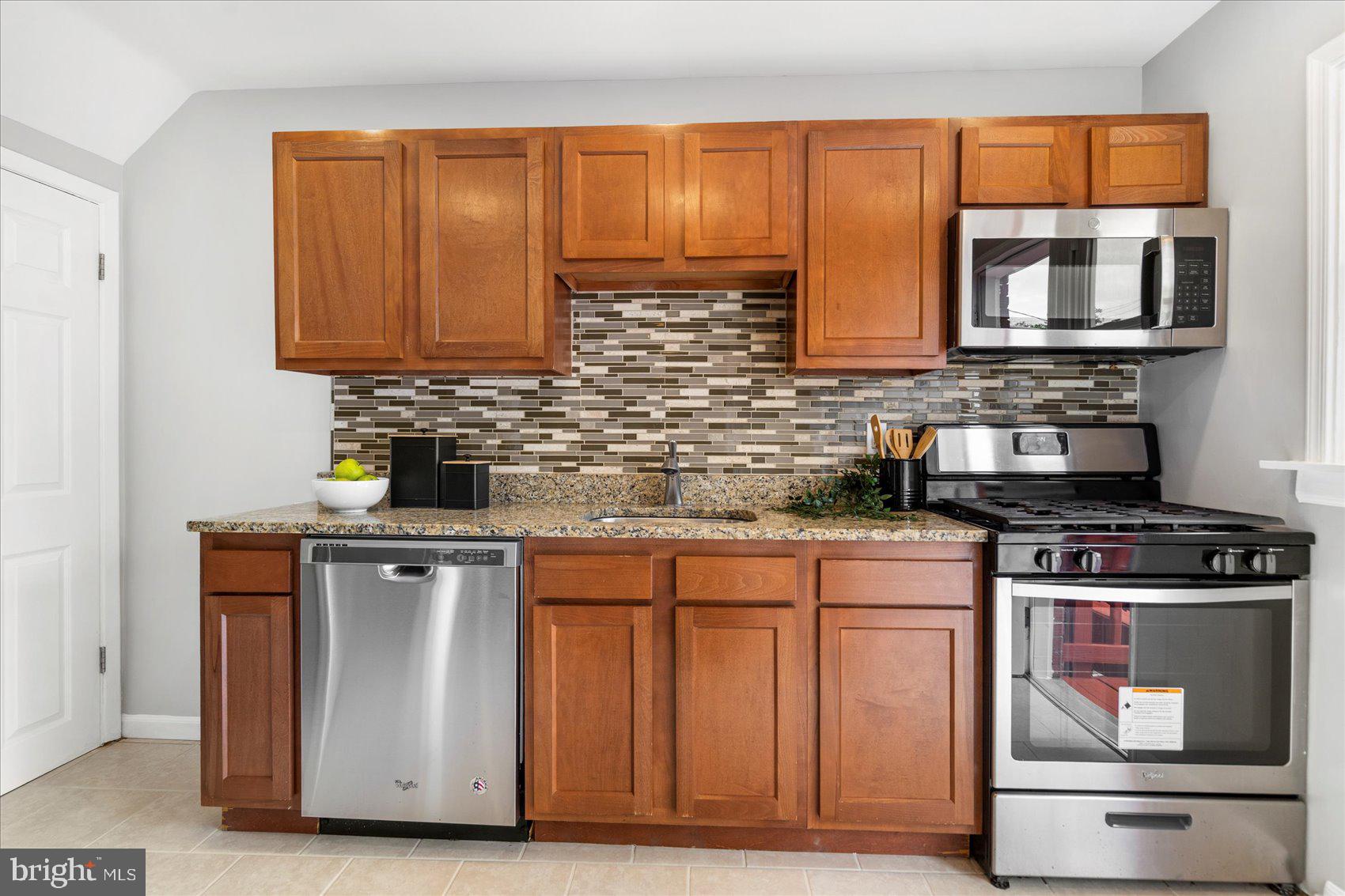 36 Bladen Road Essex, MD 21221 - Photo 13 of 34 a kitchen with stainless steel appliances granite countertop a stove a sink and a microwave