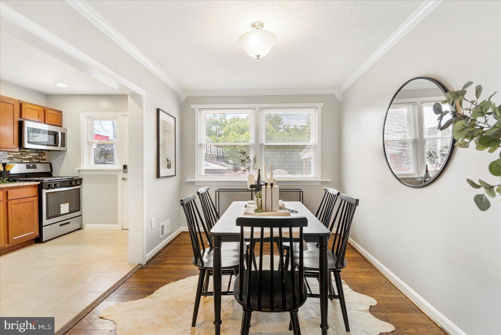 36 Bladen Road Essex, MD 21221 - Photo 10 of 34 a dining room with furniture a mirror and a window