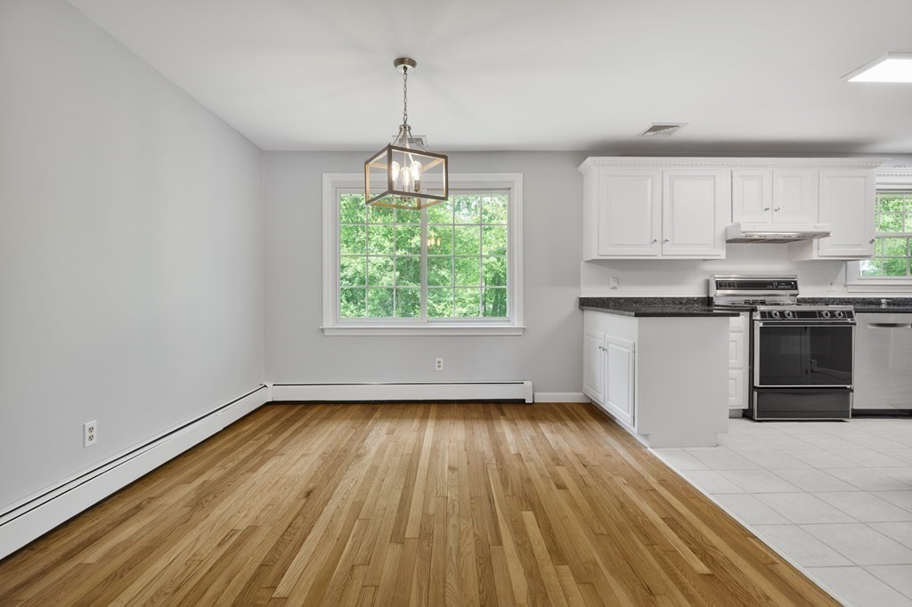 1 Potter Road Framingham, MA 01701 - Photo 9 of 41 a kitchen with wooden floors and a window