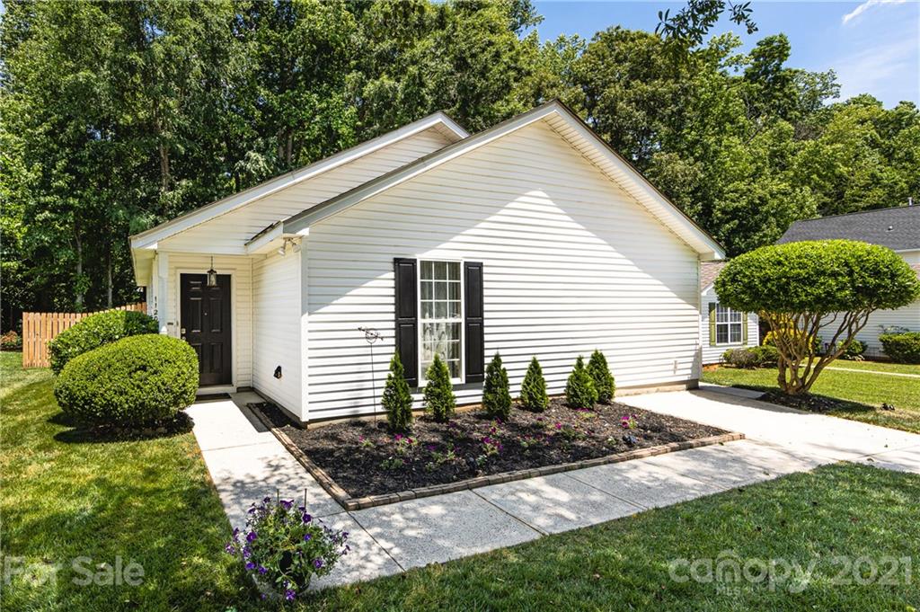 11207 Gold Pan Road Charlotte, NC 28215 - Photo 1 of 19 a front view of a house with garden