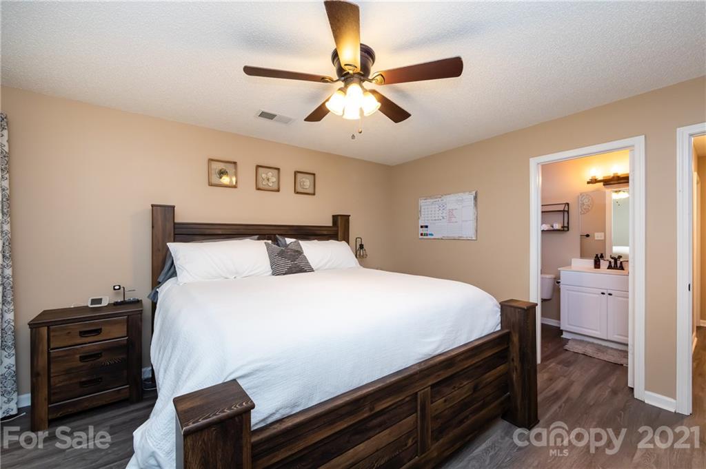 11207 Gold Pan Road Charlotte, NC 28215 - Photo 12 of 19 a bedroom with a bed and a ceiling fan