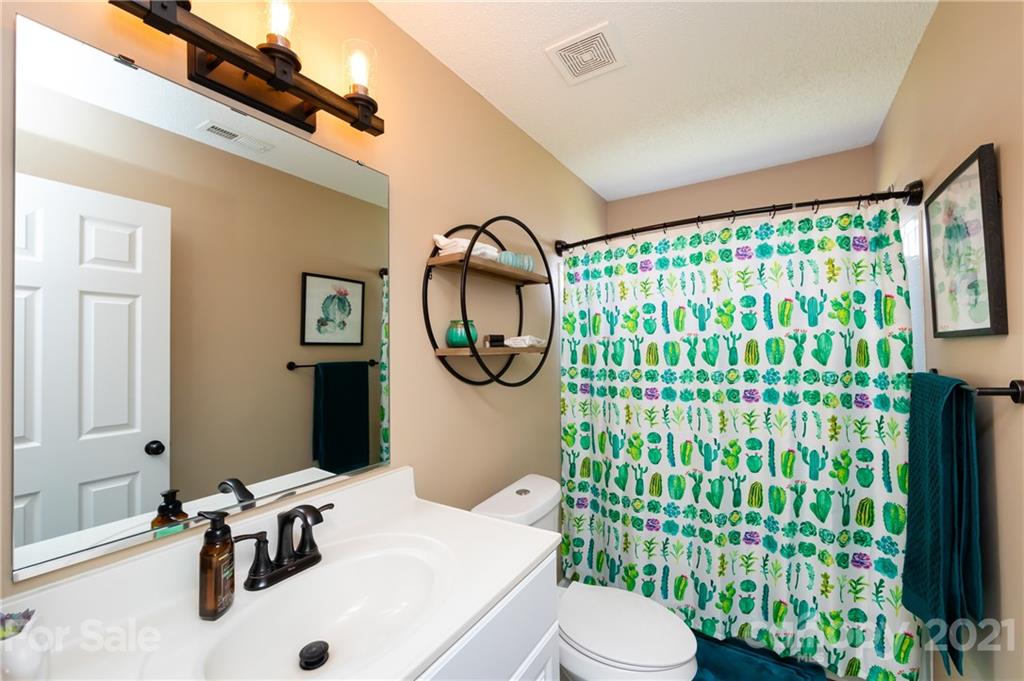 11207 Gold Pan Road Charlotte, NC 28215 - Photo 15 of 19 a bathroom with a sink toilet and shower