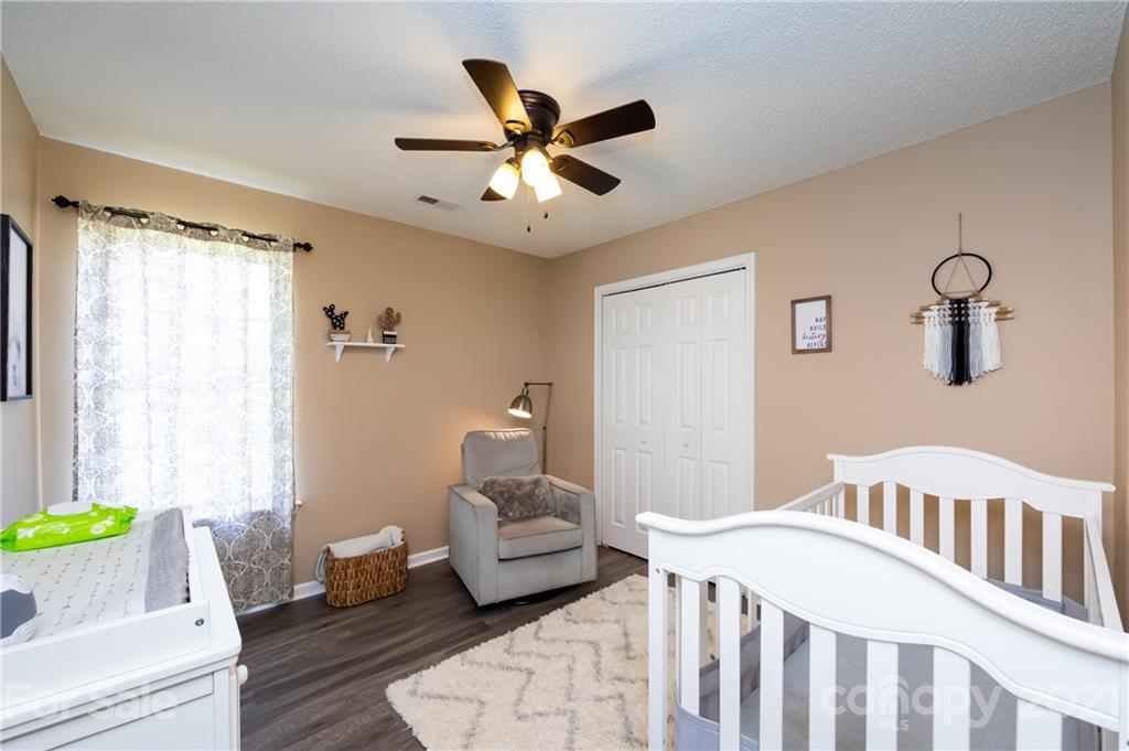 11207 Gold Pan Road Charlotte, NC 28215 - Photo 17 of 19 a bedroom with a bed and a couch