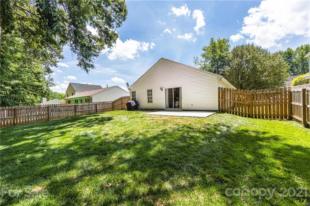 11207 Gold Pan Road Charlotte, NC 28215 - Photo 19 of 19 a view of a house with a yard and fence