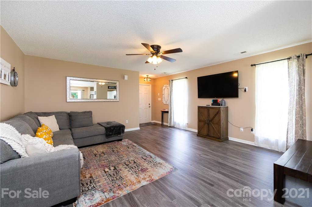11207 Gold Pan Road Charlotte, NC 28215 - Photo 6 of 19 a living room with furniture and a flat screen tv