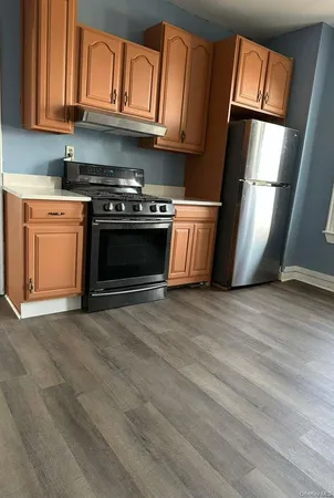 a kitchen with stainless steel appliances granite countertop a stove a refrigerator and a microwave