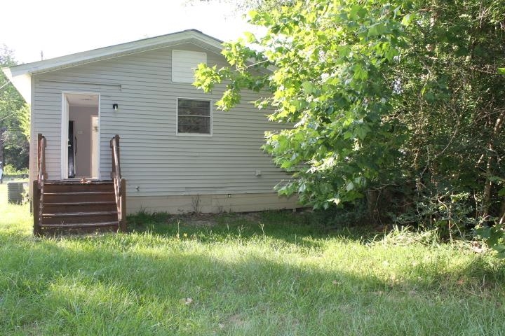 875 Woodrow Street Silsbee, TX 77656 - Photo 7 of 30 a view of a back yard of the house
