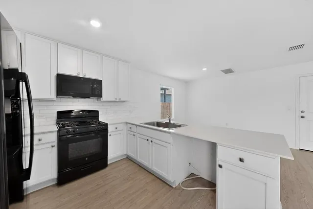 a kitchen with a refrigerator stove and sink