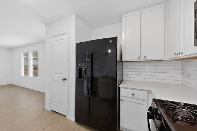 a kitchen with stainless steel appliances granite countertop a stove and a refrigerator