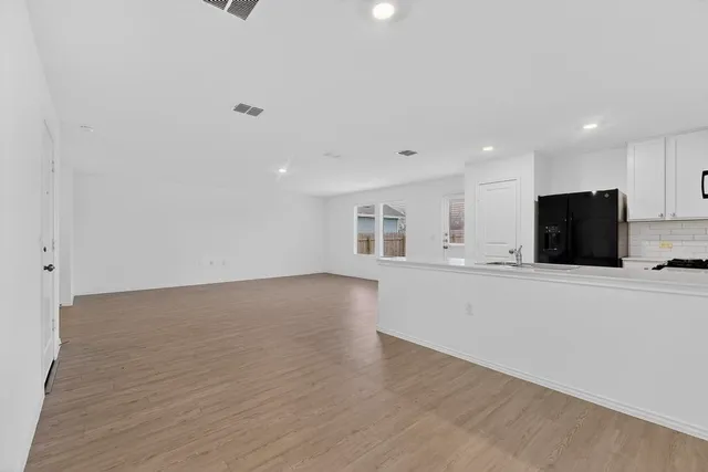 a view of kitchen with stainless steel appliances refrigerator sink and microwave