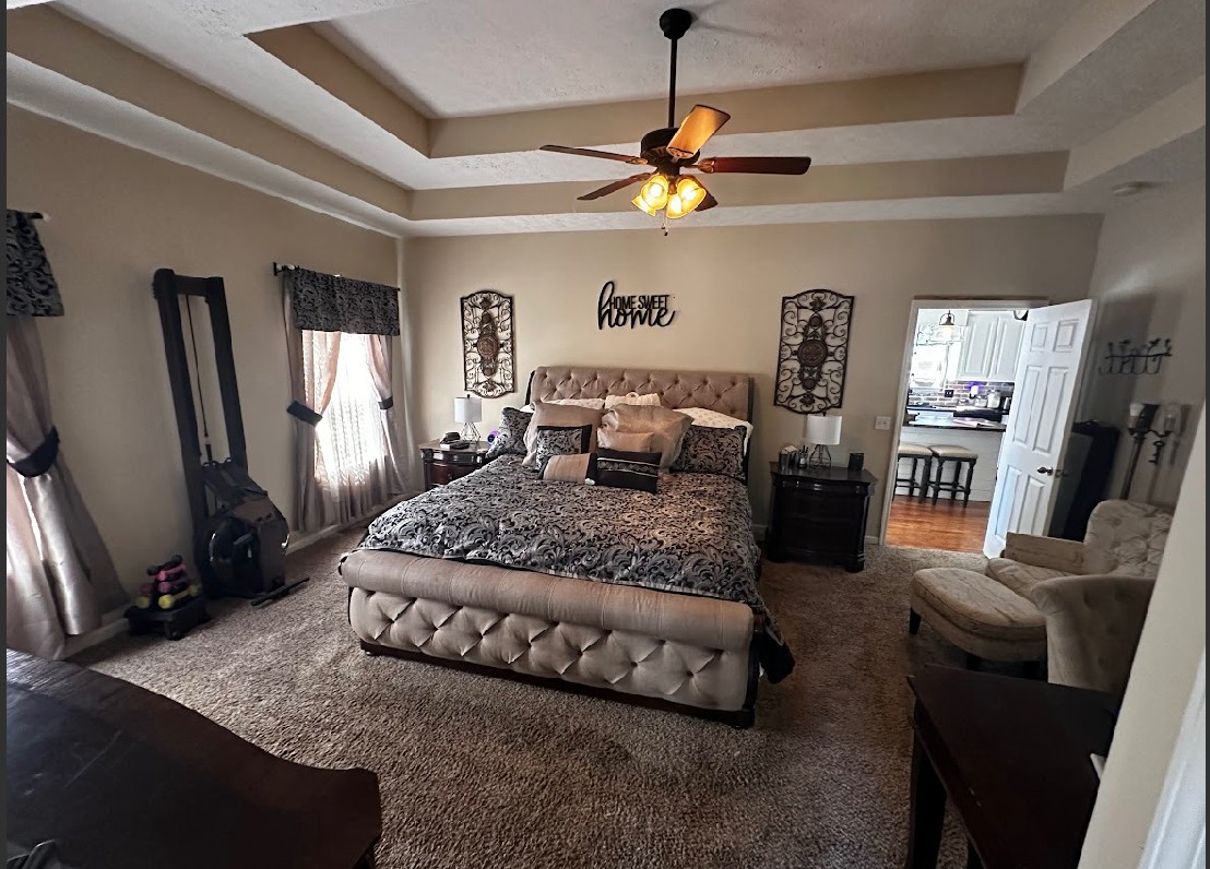 495 Calista Road White House, TN 37188 - Photo 16 of 28 a bedroom with a large bed a flat tv screen and a dresser