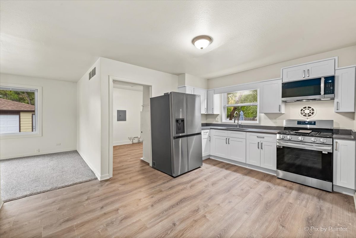 288 North Addison Road Wood Dale, IL 60191 - Photo 12 of 23 a kitchen with a refrigerator and a stove top oven