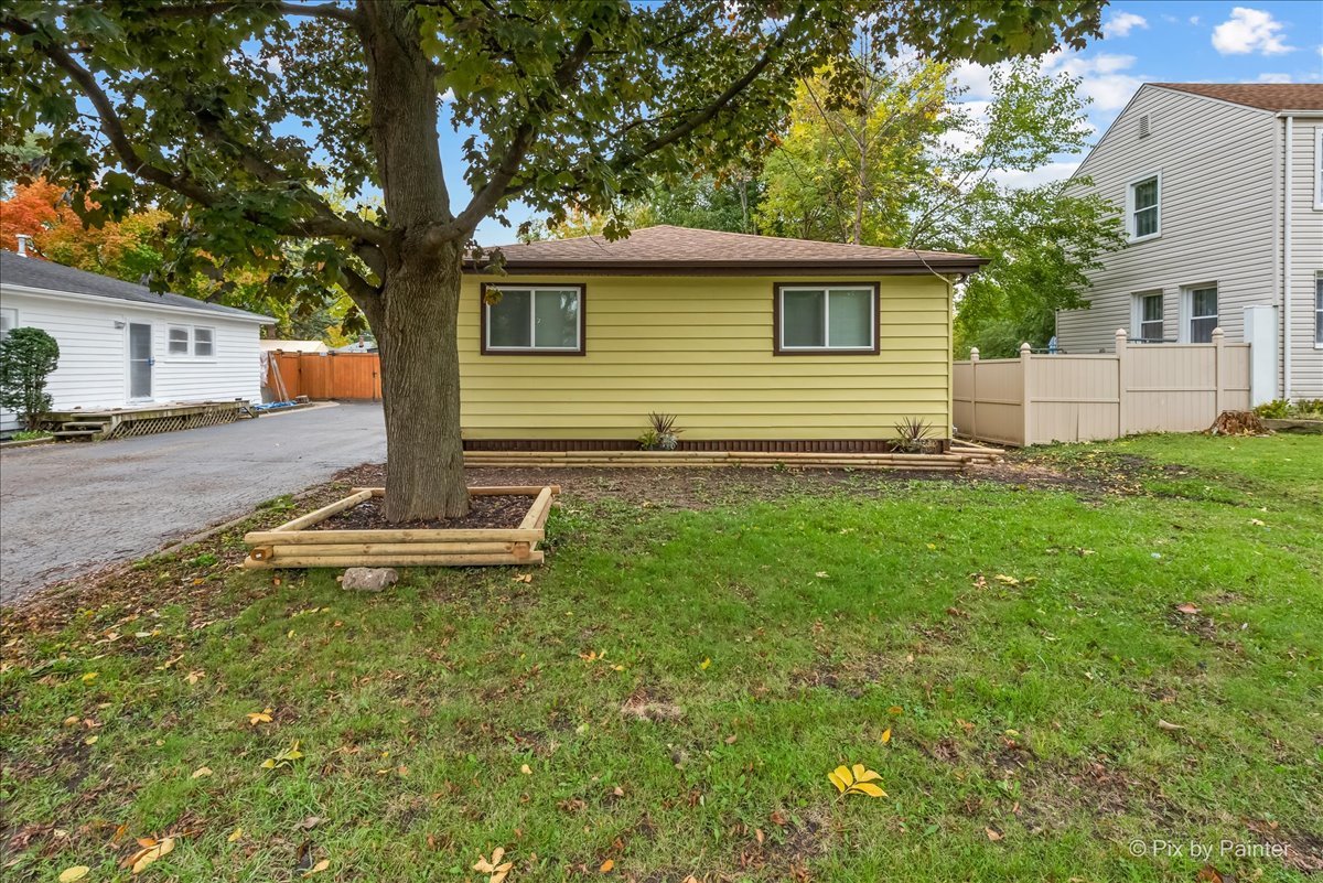 288 North Addison Road Wood Dale, IL 60191 - Photo 2 of 23 a front view of a house with garden