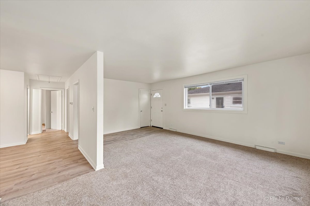 288 North Addison Road Wood Dale, IL 60191 - Photo 10 of 23 an empty room with windows