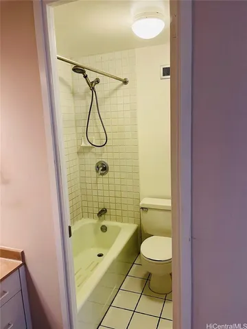 a bathroom with a granite countertop toilet a sink and a shower