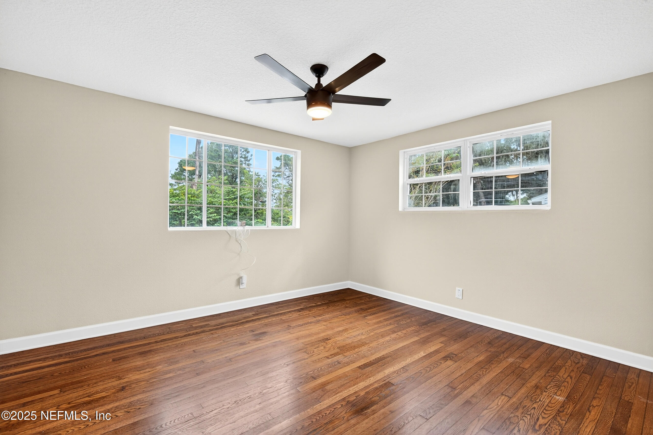 9906 Jeanette Road Jacksonville, FL 32246 - Photo 12 of 32 a view of a big room with wooden floor and windows