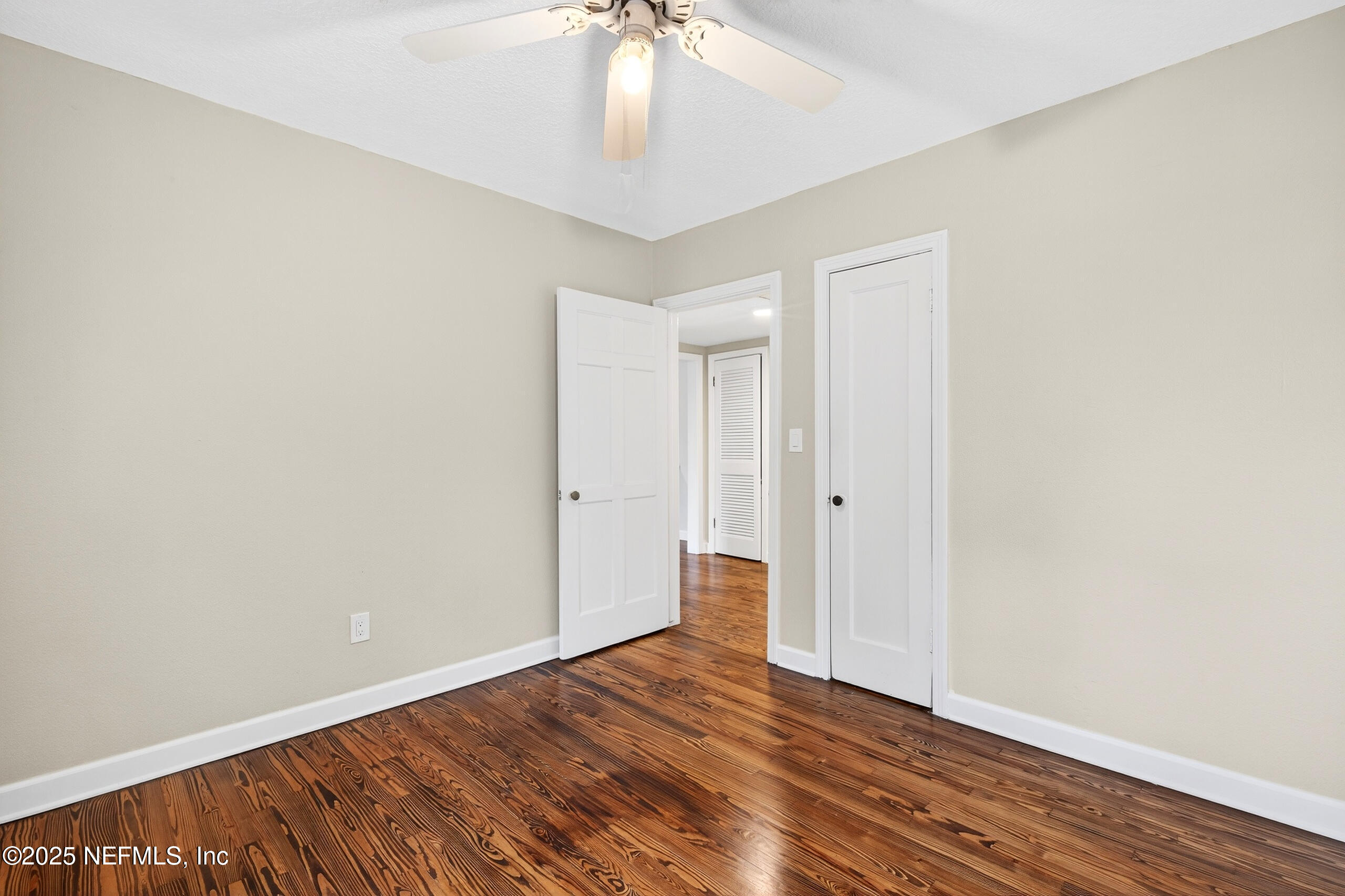 9906 Jeanette Road Jacksonville, FL 32246 - Photo 17 of 32 a view of an empty room with wooden floor