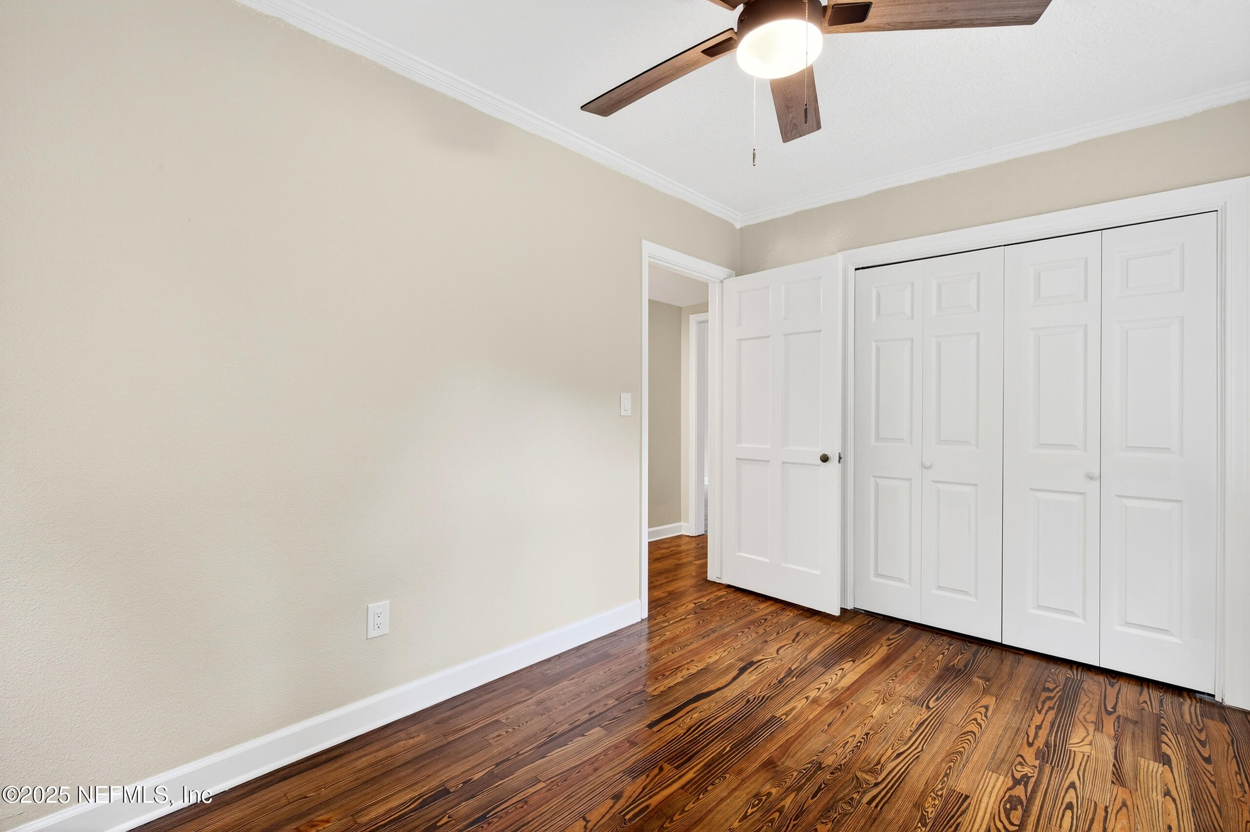 9906 Jeanette Road Jacksonville, FL 32246 - Photo 19 of 32 a view of an empty room with wooden floor