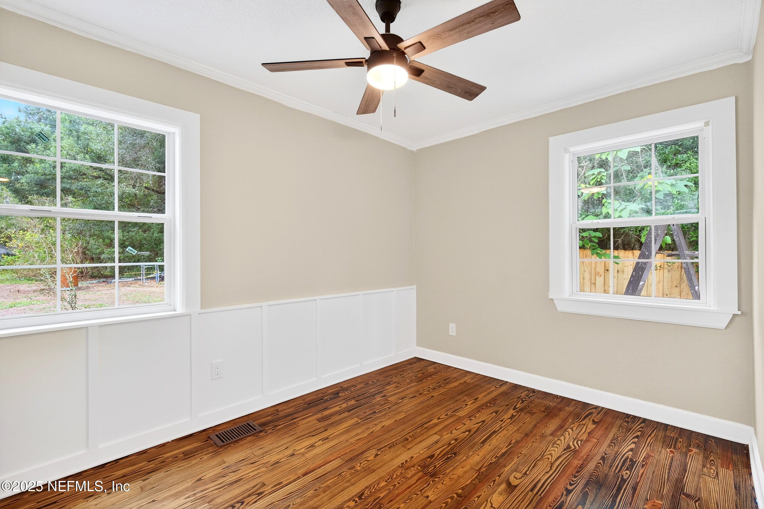 9906 Jeanette Road Jacksonville, FL 32246 - Photo 20 of 32 an empty room with a window and wooden floor
