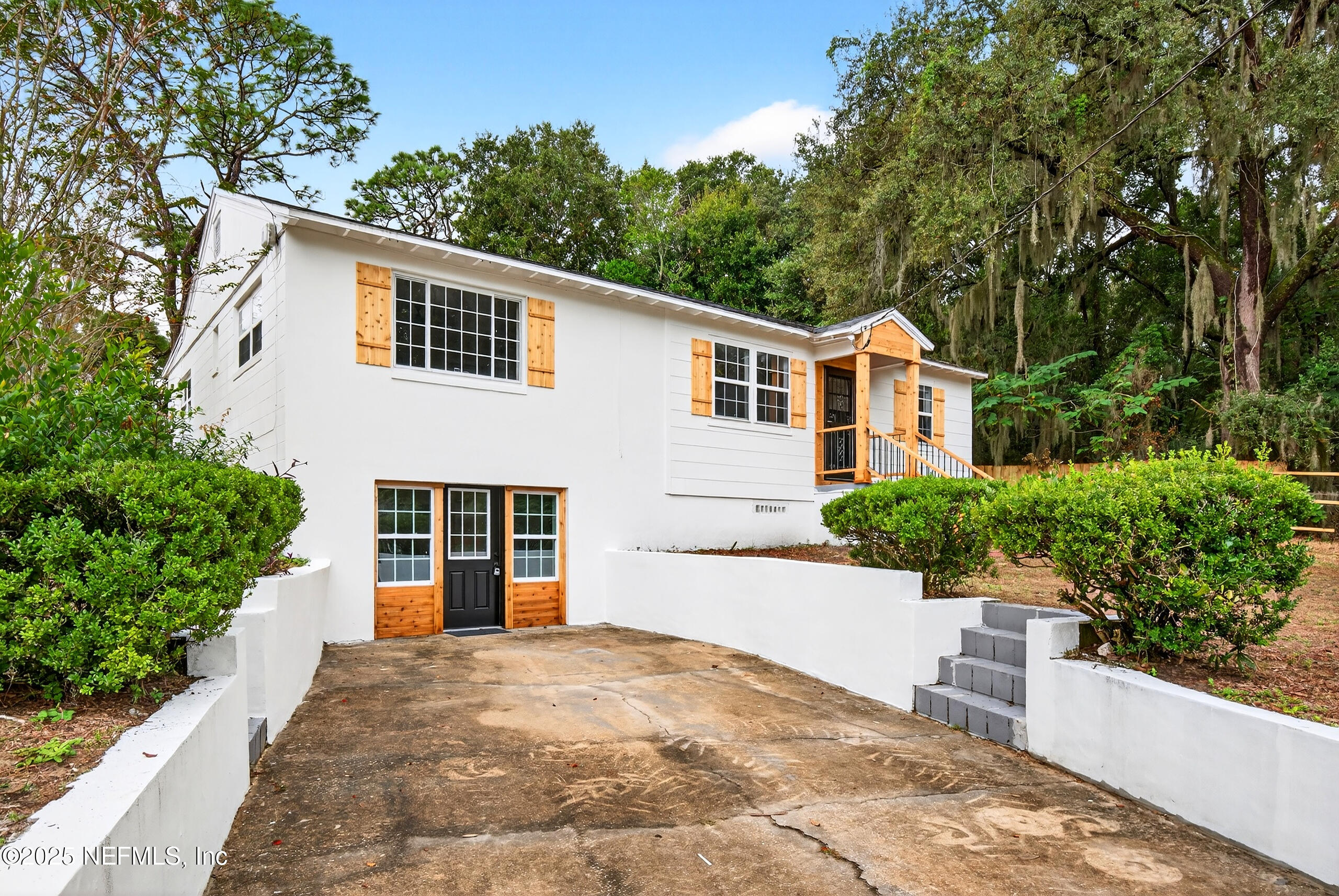 9906 Jeanette Road Jacksonville, FL 32246 - Photo 2 of 32 a front view of a house with a yard and trees