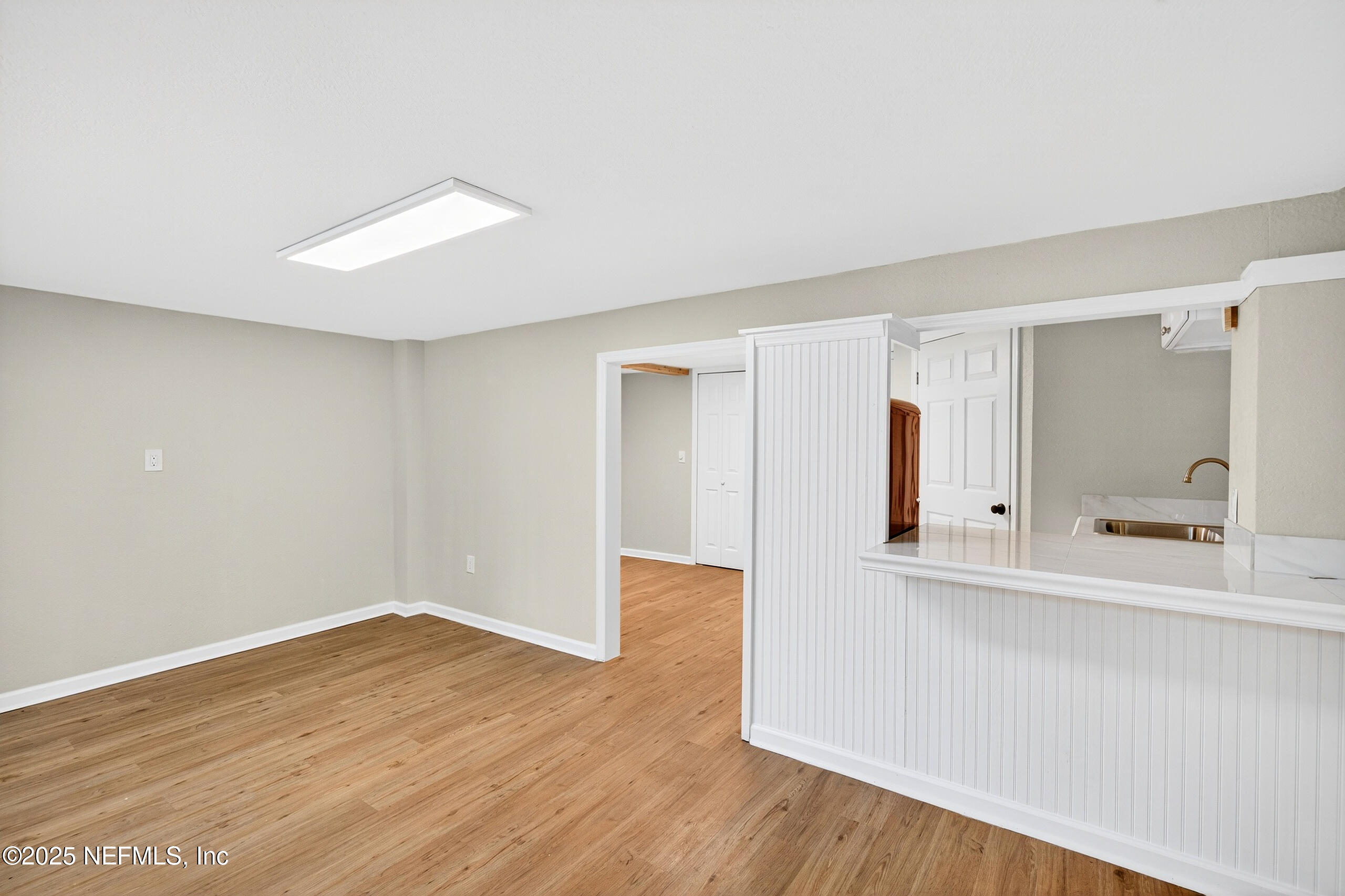 9906 Jeanette Road Jacksonville, FL 32246 - Photo 21 of 32 a view of a room with wooden floor and a window
