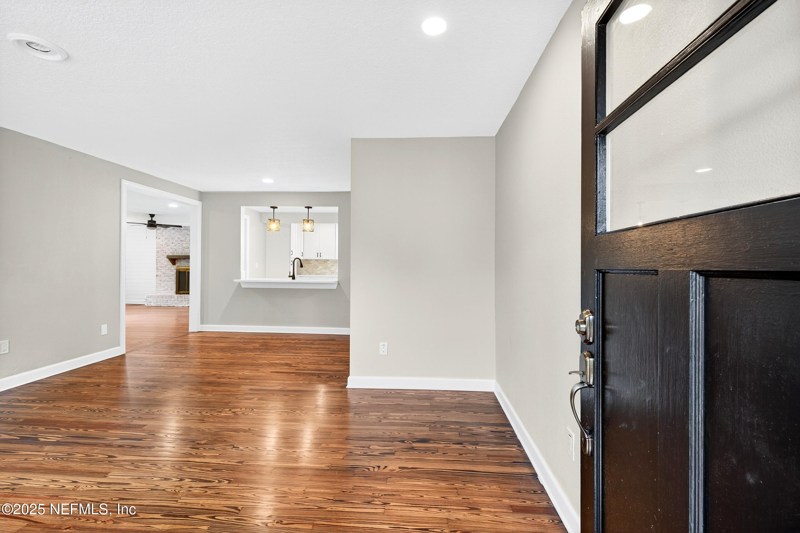 9906 Jeanette Road Jacksonville, FL 32246 - Photo 3 of 32 a view of a kitchen with wooden floor and a refrigerator