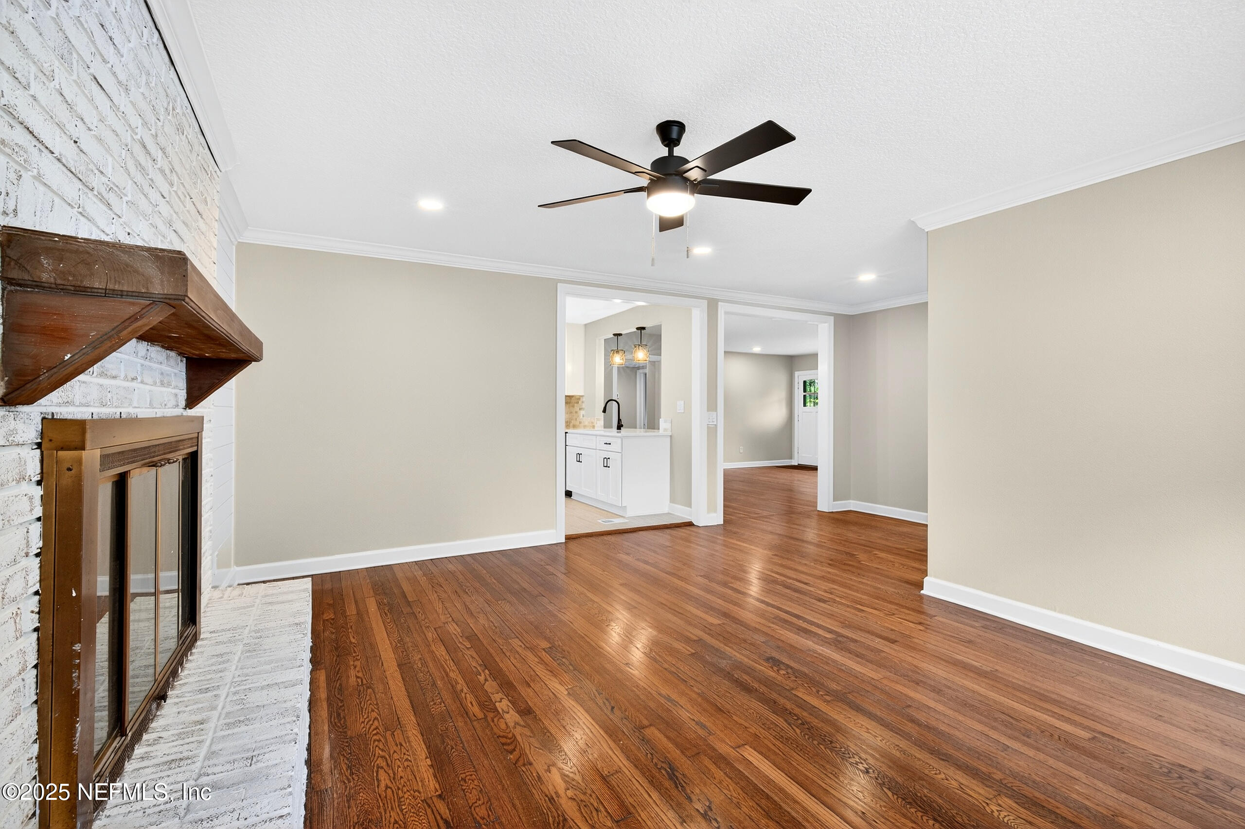 9906 Jeanette Road Jacksonville, FL 32246 - Photo 7 of 32 a view of an empty room with wooden floor and a window