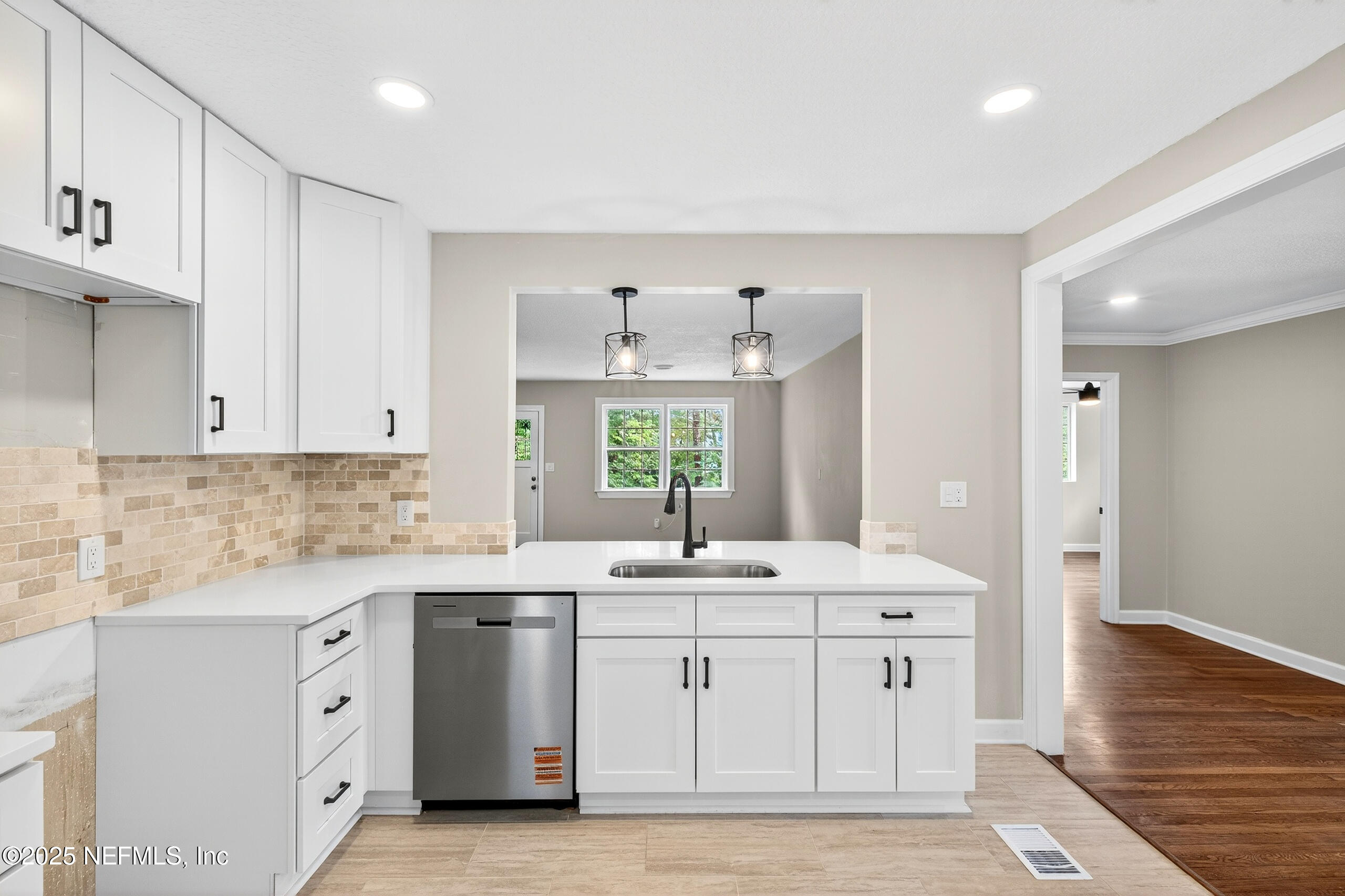 9906 Jeanette Road Jacksonville, FL 32246 - Photo 10 of 32 a kitchen with a sink stove and cabinets