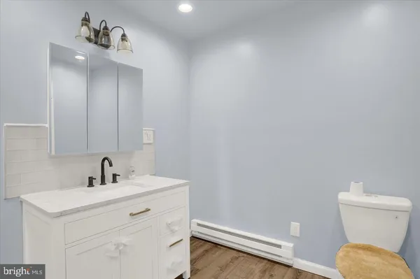 a bathroom with a sink a toilet and a mirror