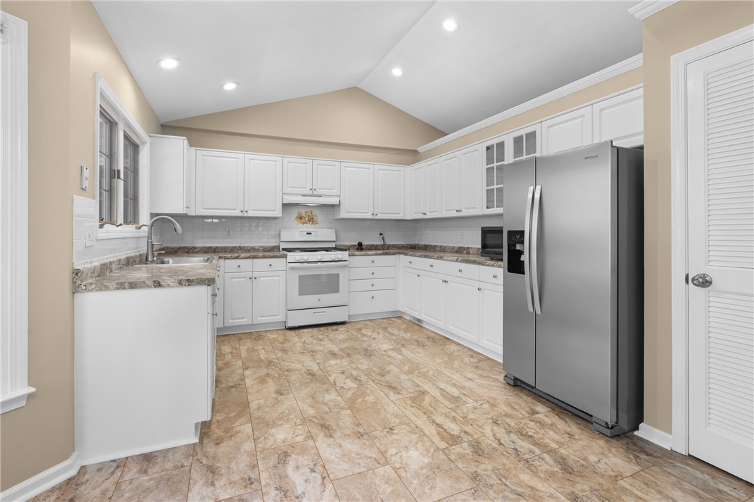 429 Burns Mill Road West Union, SC 29696 - Photo 12 of 49 Prepare meals in a kitchen featuring sleek white cabinetry and generous counter space.