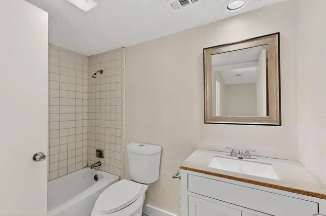 a view of a room with wooden floor and a ceiling fan