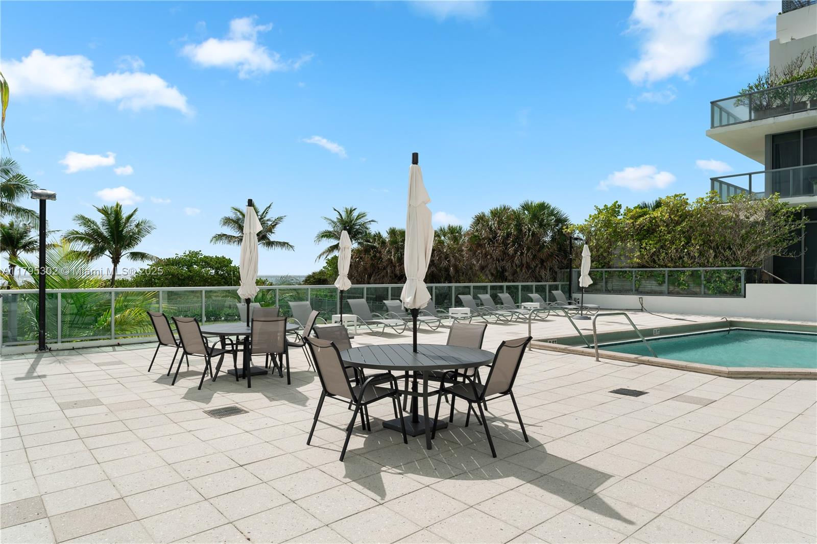 9511 Collins Avenue, Unit 301 Surfside, FL 33154 - Photo 13 of 15 a view of a patio with a table and chairs