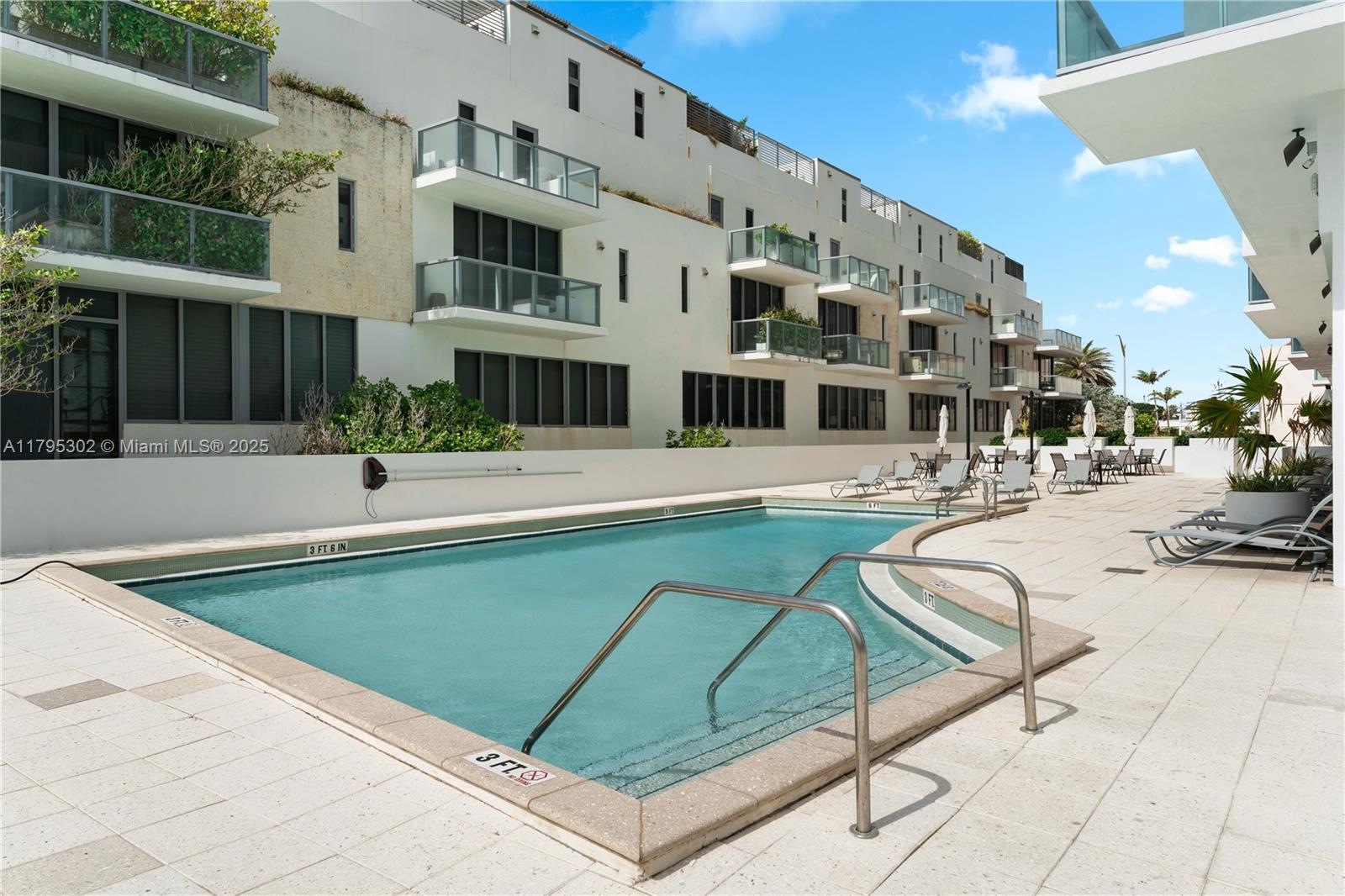 9511 Collins Avenue, Unit 301 Surfside, FL 33154 - Photo 14 of 15 a view of building with swimming pool and sitting area