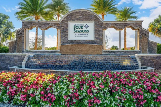 a view of a house with swimming pool and sitting area