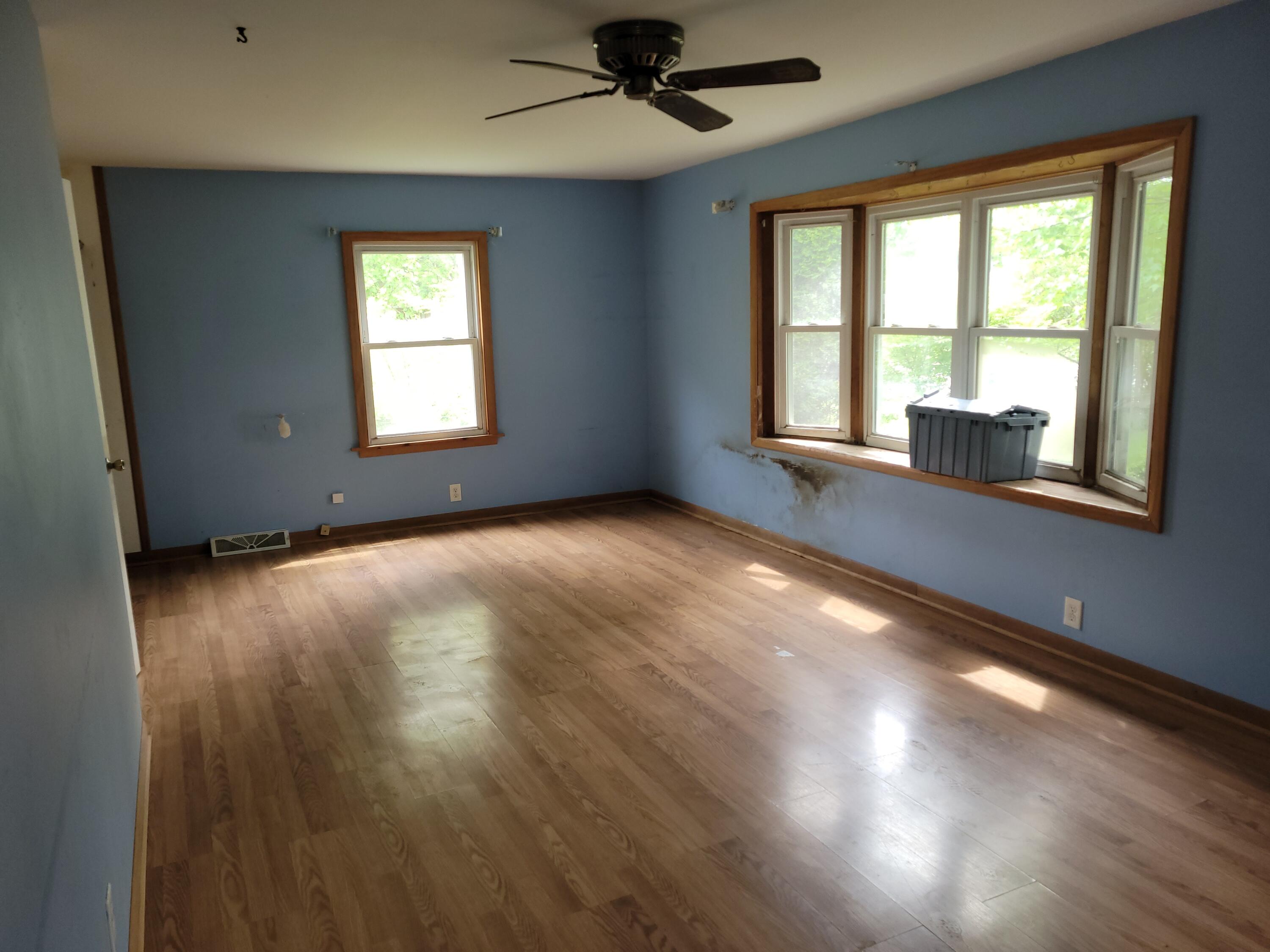 63 Deerpath Road Merrillville, IN 46410 - Photo 3 of 14 a view of an empty room with wooden floor and a window