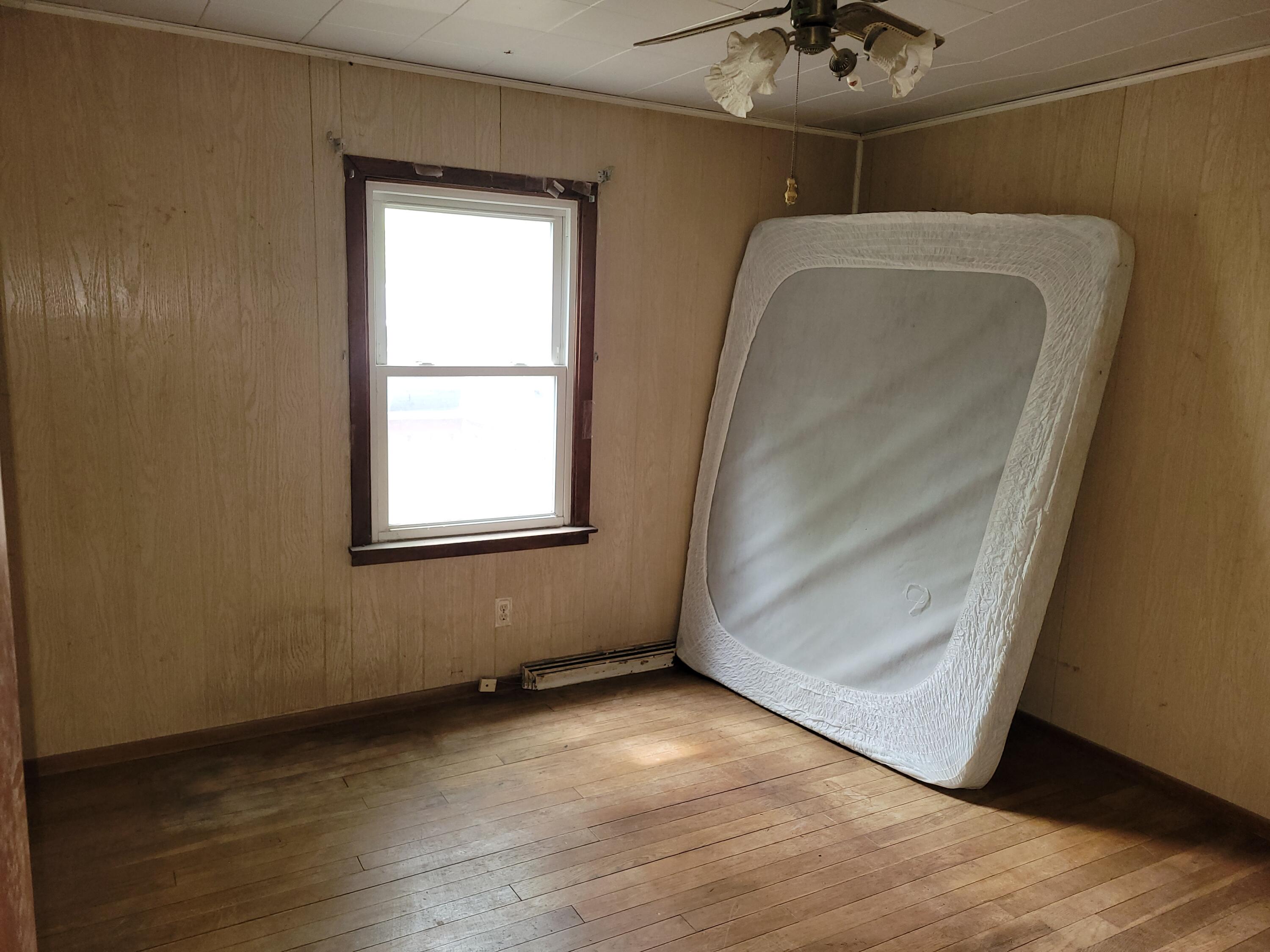 63 Deerpath Road Merrillville, IN 46410 - Photo 6 of 14 an empty room with wooden floor and windows