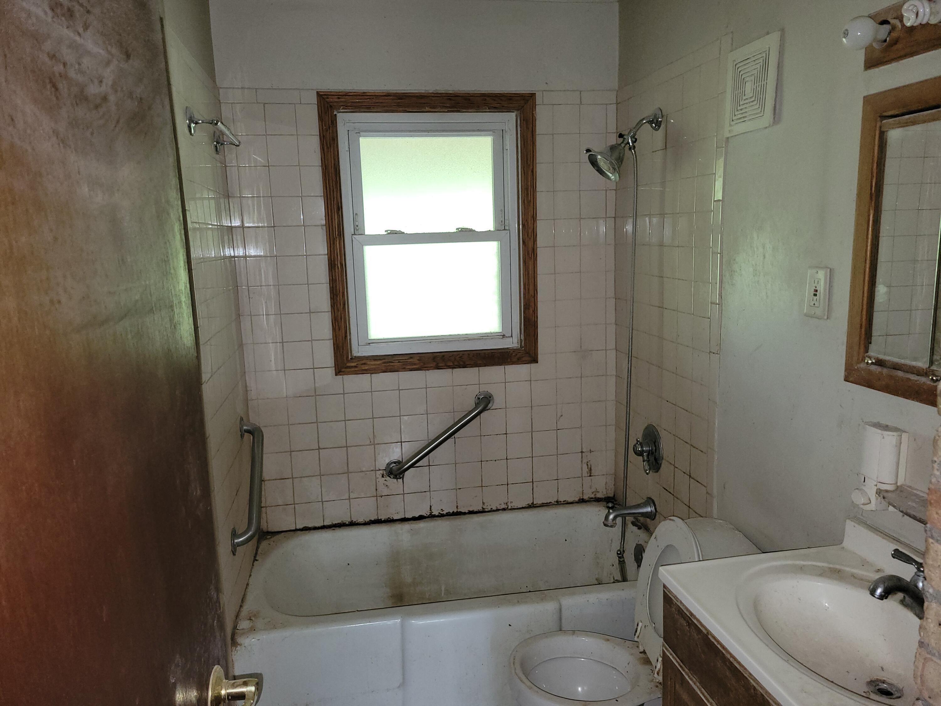 63 Deerpath Road Merrillville, IN 46410 - Photo 10 of 14 a bathroom with a sink toilet and shower