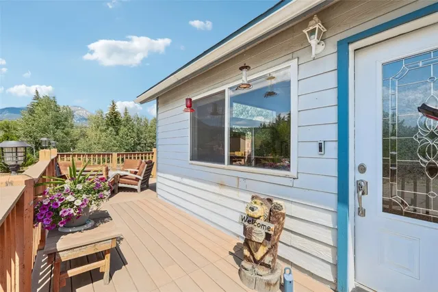 a balcony with wooden floor and furniture