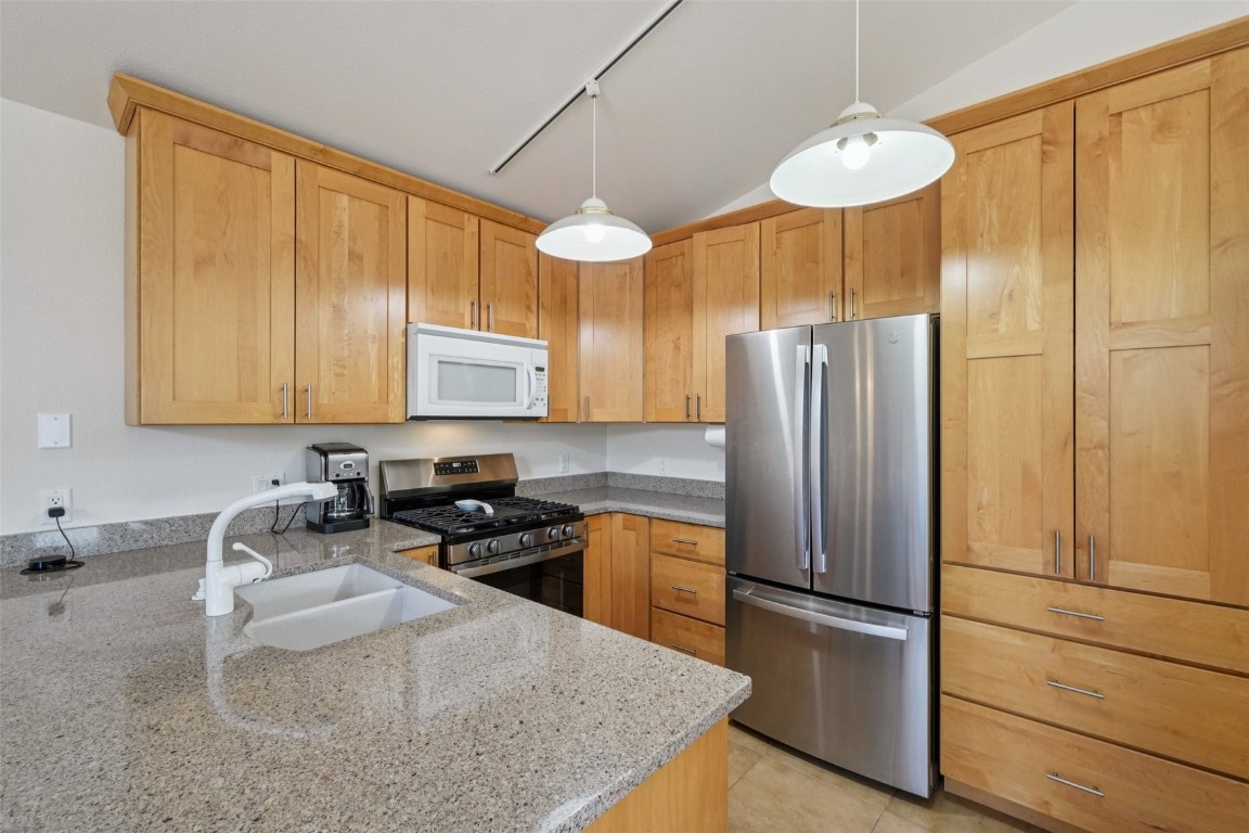 380 Riley Road Silverthorne, CO 80498 - Photo 26 of 49 a kitchen with stainless steel appliances granite countertop a refrigerator a sink a stove and a wooden floors