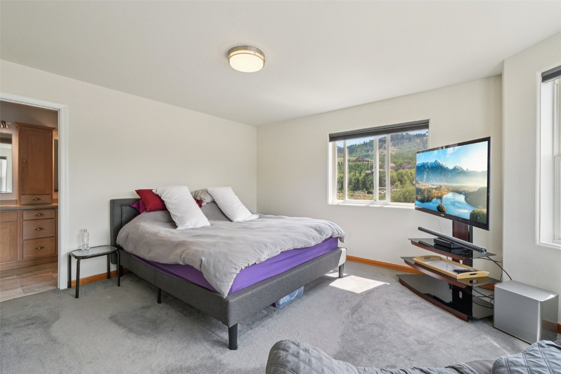 380 Riley Road Silverthorne, CO 80498 - Photo 28 of 49 a bedroom with a bed and large windows