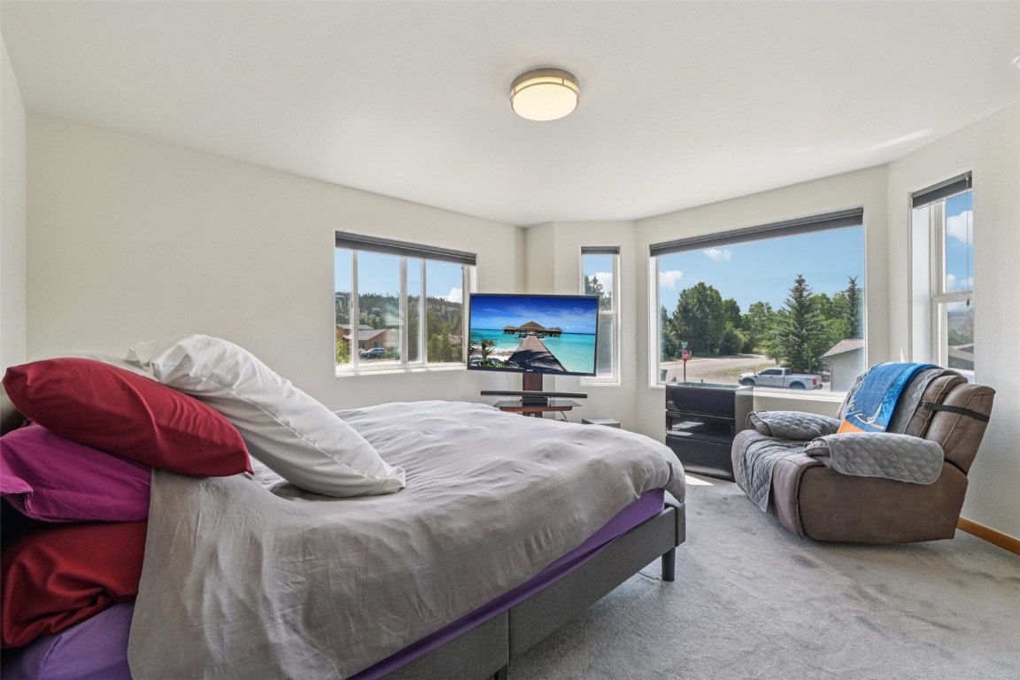 380 Riley Road Silverthorne, CO 80498 - Photo 29 of 49 a bedroom with a bed and a large window