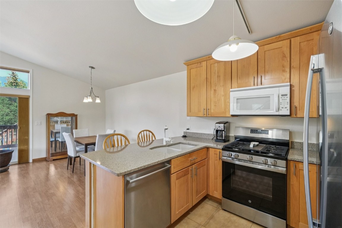 380 Riley Road Silverthorne, CO 80498 - Photo 3 of 49 a kitchen with stainless steel appliances a stove a sink and a refrigerator