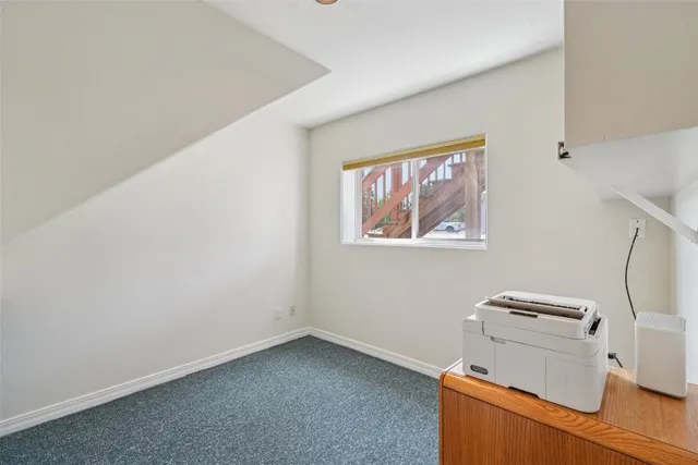 a view of room with cabinet and wooden floor