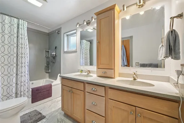 a bathroom with a double vanity sink mirror double and shower