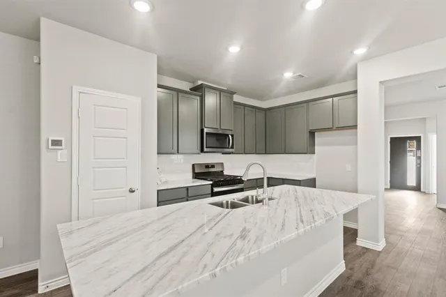 a large bedroom with a bed and a view of living room