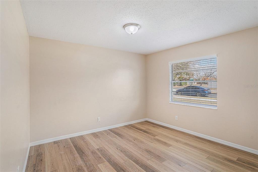 2527 Ridge Top Way Valrico, FL 33594 - Photo 19 of 29 a view of an empty room with wooden floor and a window