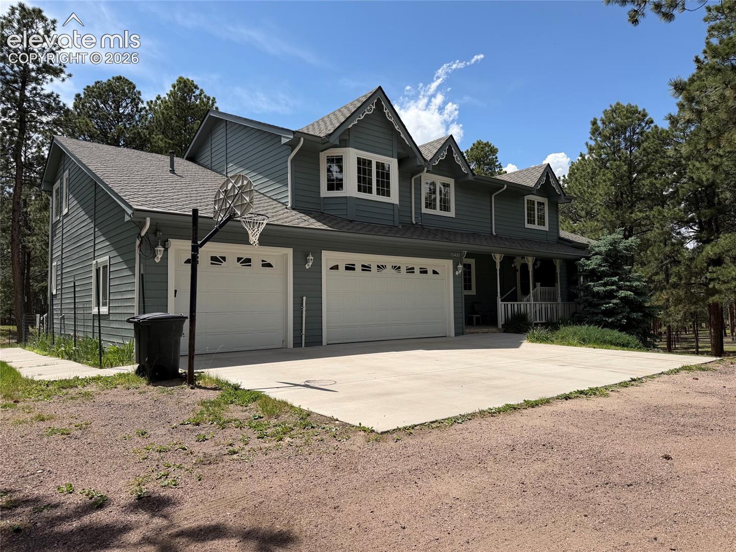 15430 Bar X Road Colorado Springs, CO 80908 - Photo 1 of 50 Custom 2-story home with newer roof and a chip and seal asphalt driveway with inground basketball hoop.