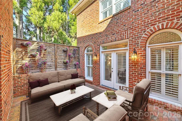 a outdoor space with patio the couches and a dining table with large window